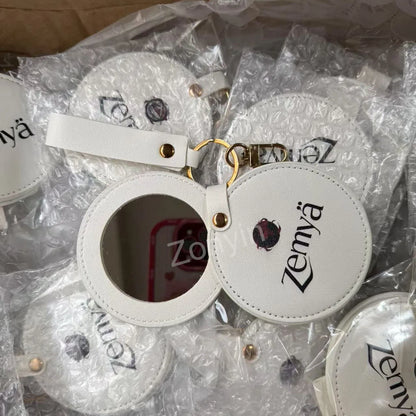 Zonyin LOW MOQ Customized Logo Round Pocket Cosmetic Mirror Pu Leather Portable Small Compact Makeup Mirror with Keychain