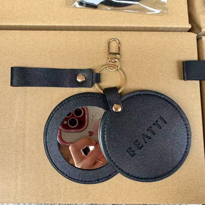 Zonyin LOW MOQ Customized Logo Round Pocket Cosmetic Mirror Pu Leather Portable Small Compact Makeup Mirror with Keychain
