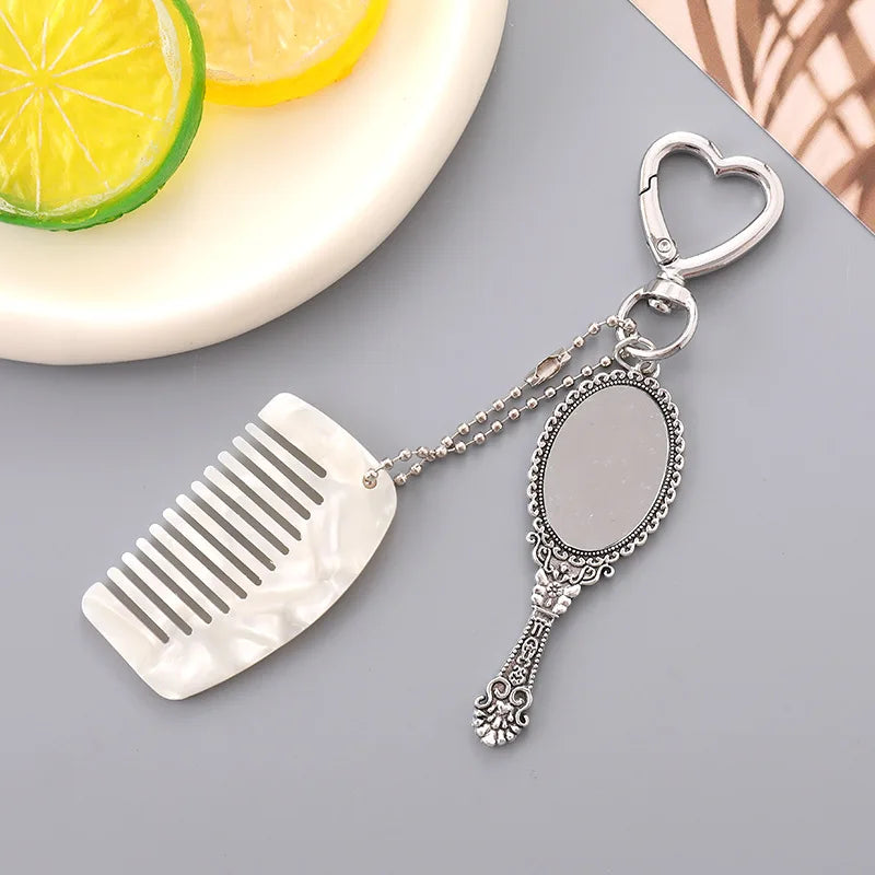 Zonyin Wholesale Mini Handle Handheld Makeup Mirror Keychain with Pendant Comb Mobile Phone Hanging Bag Decorative Accessories
