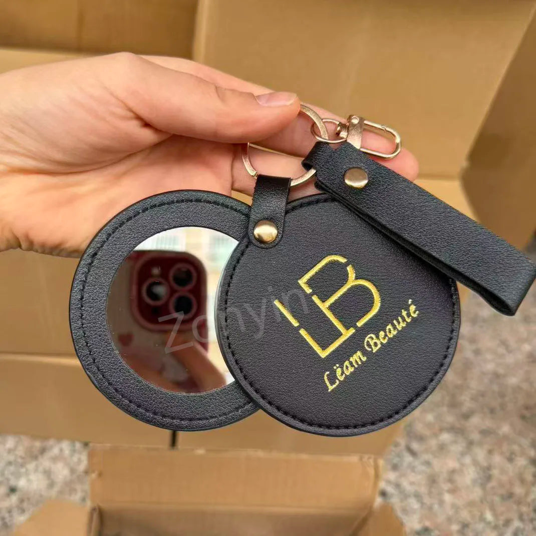 Zonyin LOW MOQ Customized Logo Round Pocket Cosmetic Mirror Pu Leather Portable Small Compact Makeup Mirror with Keychain